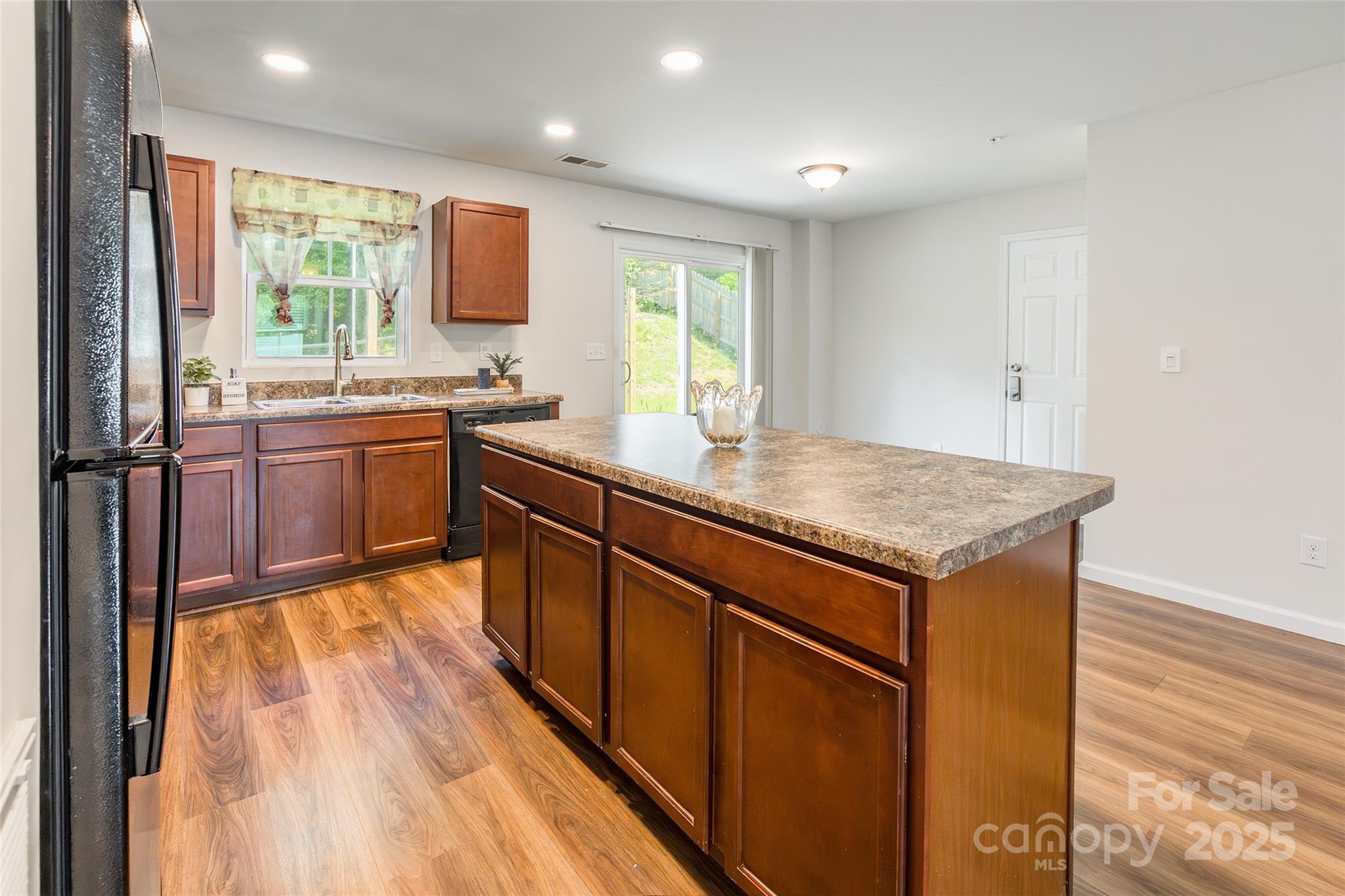 1128 Tangle Ridge Drive Southeast Concord, NC 28025 - Photo 8 of 27 a kitchen with stainless steel appliances granite countertop a sink stove and refrigerator