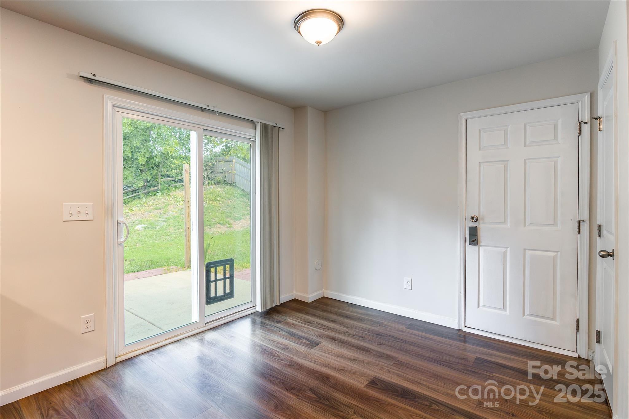 1128 Tangle Ridge Drive Southeast Concord, NC 28025 - Photo 9 of 27 a view of an empty room with wooden floor and a window