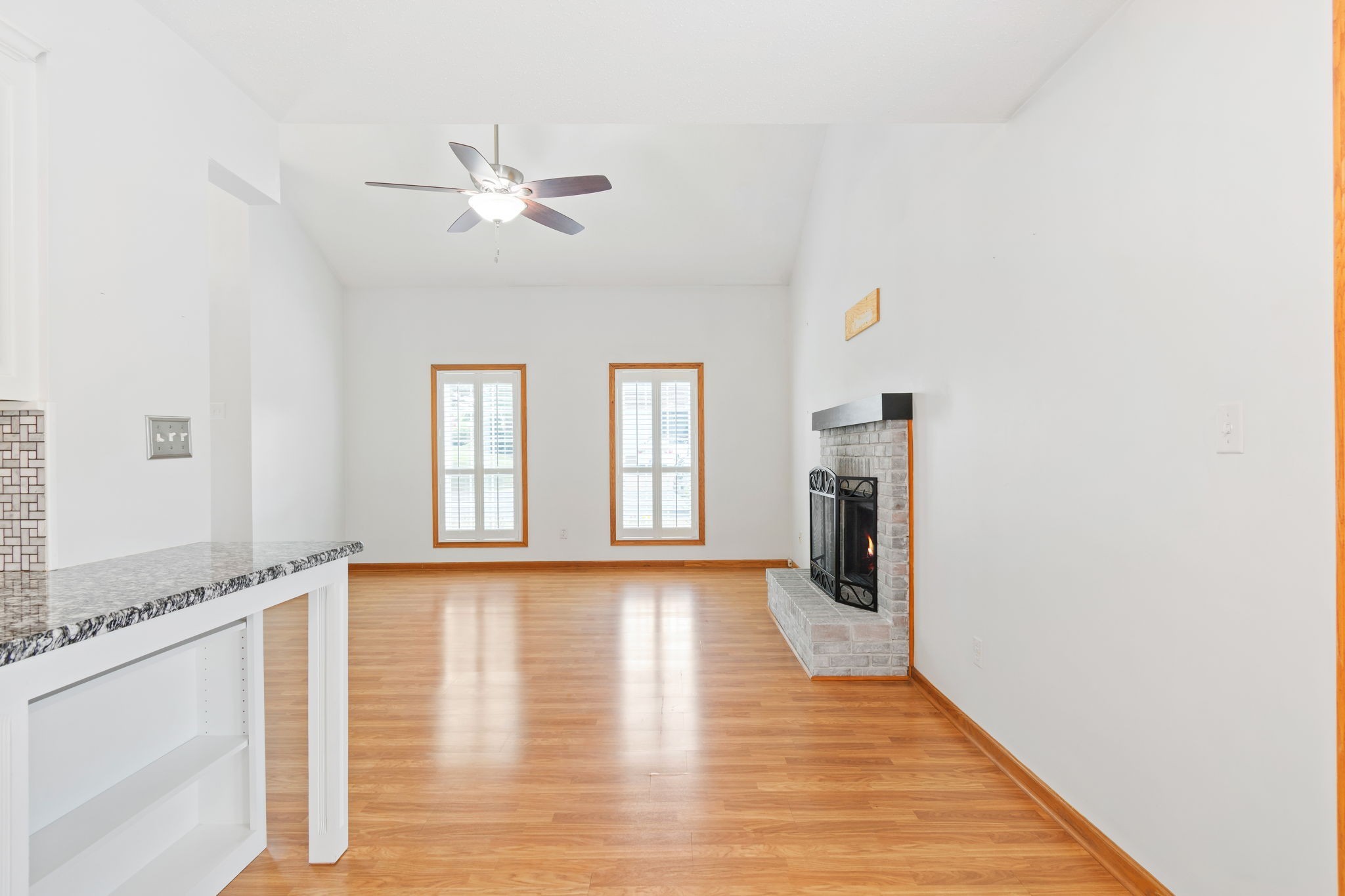 5002 Camelot Drive, Unit C Columbia, TN 38401 - Photo 11 of 46 a view of an empty room with wooden floor and a window