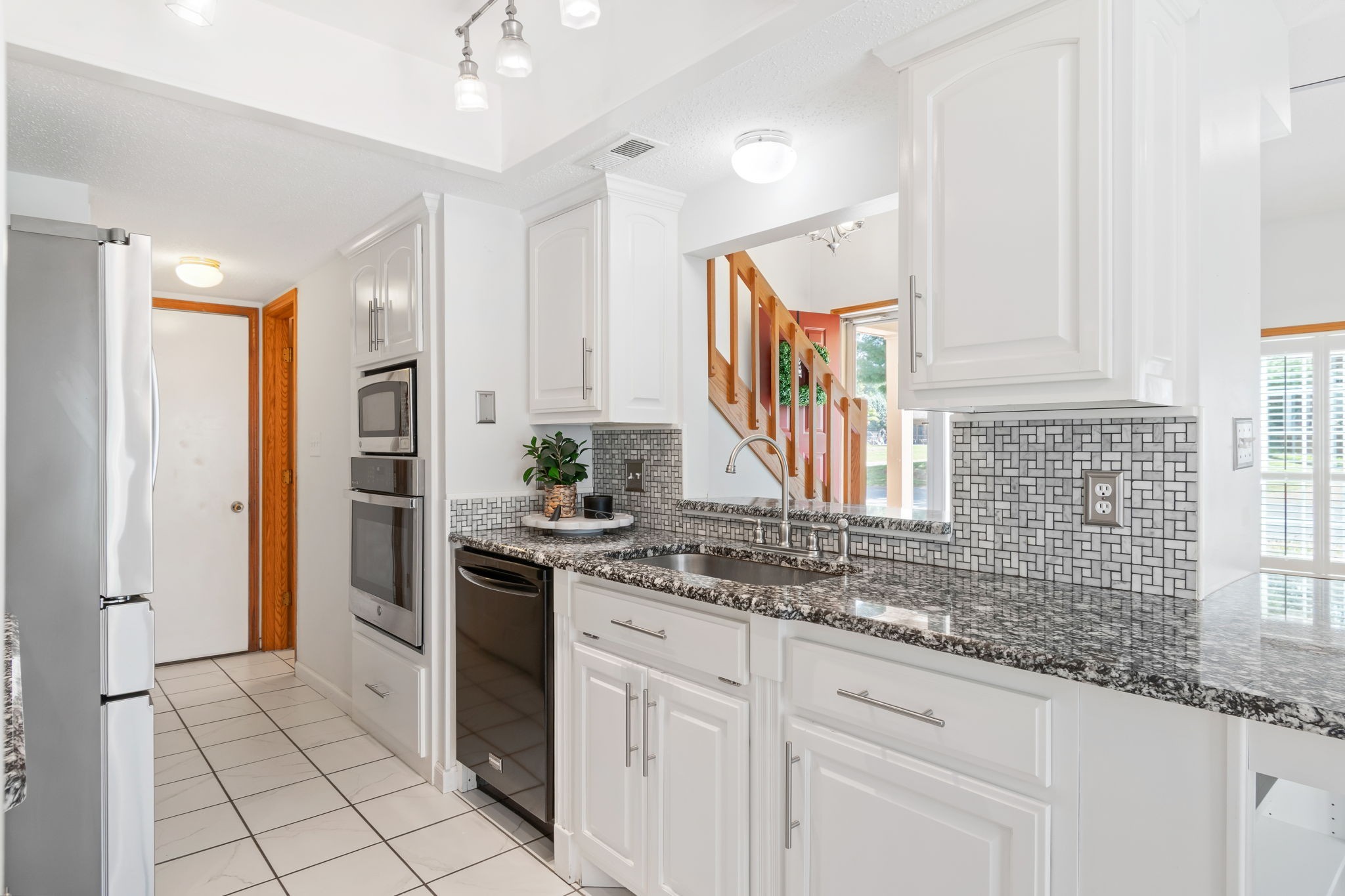 5002 Camelot Drive, Unit C Columbia, TN 38401 - Photo 12 of 46 a kitchen with stainless steel appliances granite countertop a sink and cabinets
