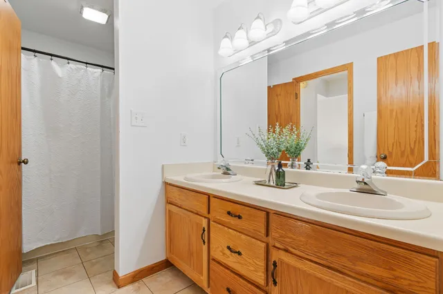 a bathroom with a double vanity sink and a mirror