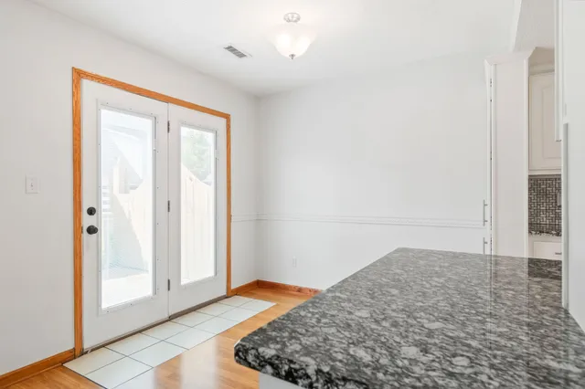 a view of a kitchen with granite countertop a stove top oven a sink and a refrigerator