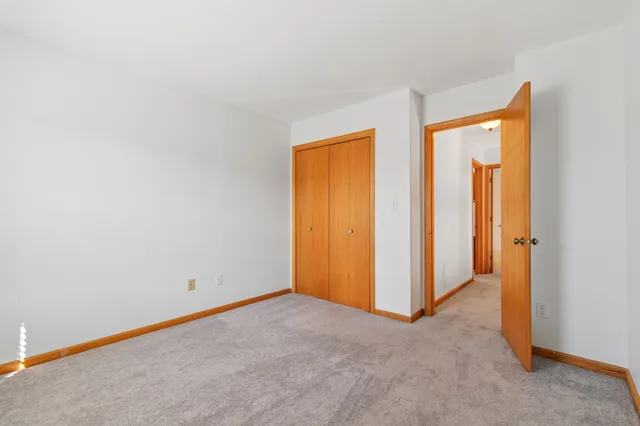 a view of staircase with white walls and railing