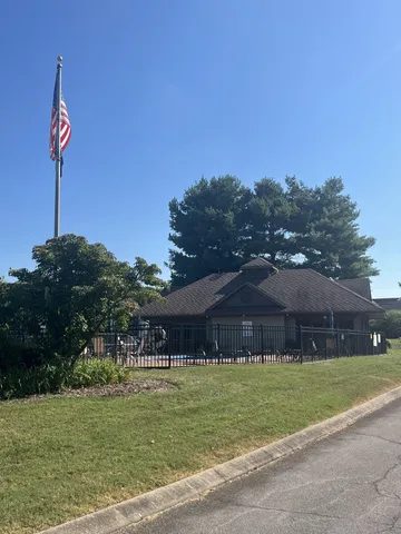 a view of a chairs and table in back of the house