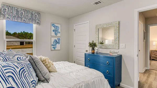 a bedroom with a bed and a painting on the wall