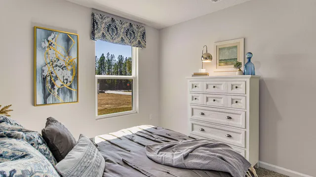 a bedroom with a bed and painting on the wall