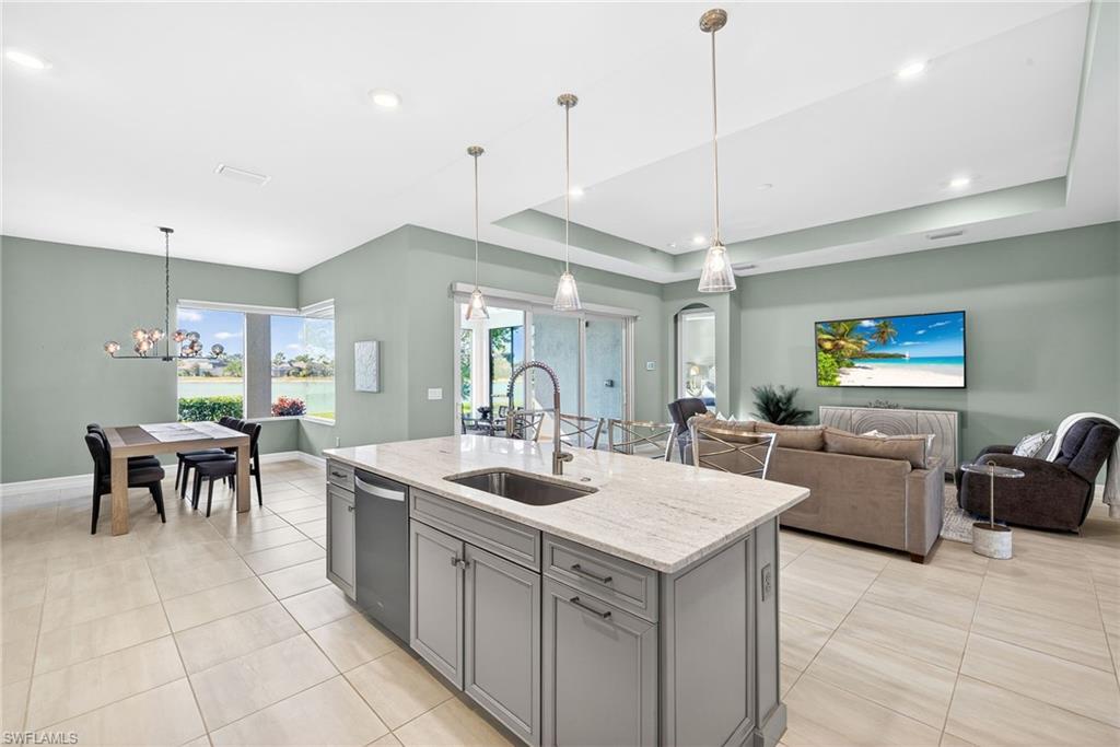 14523 Kelson Circle Naples, FL 34114 - Photo 12 of 50 a large kitchen with kitchen island a sink table and chairs