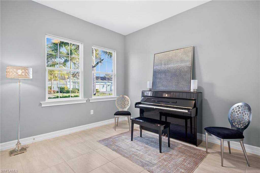 14523 Kelson Circle Naples, FL 34114 - Photo 20 of 50 a living room with furniture and a window