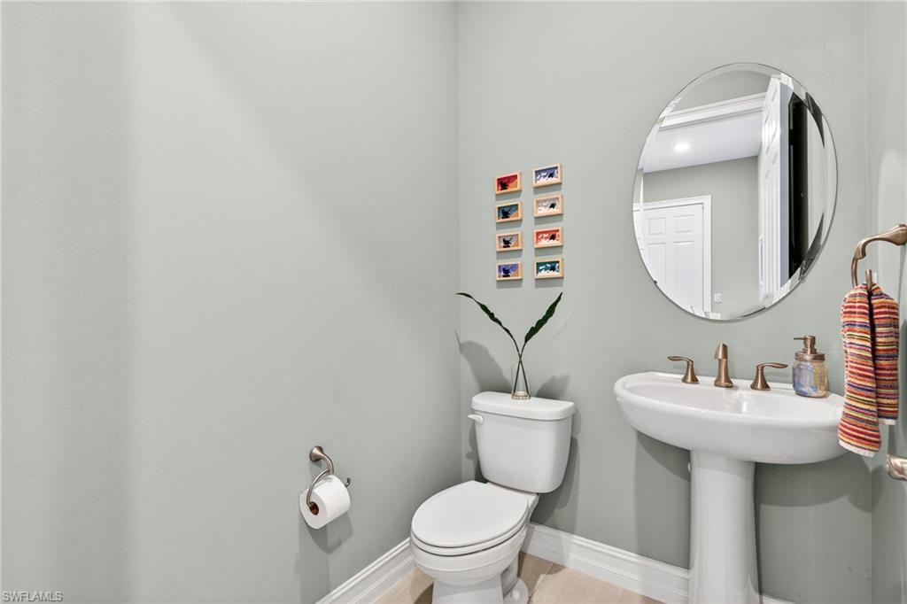 14523 Kelson Circle Naples, FL 34114 - Photo 26 of 50 a bathroom with a toilet sink and mirror