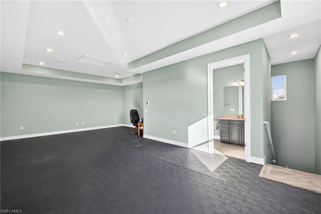 14523 Kelson Circle Naples, FL 34114 - Photo 28 of 50 an empty room with wooden floor and windows