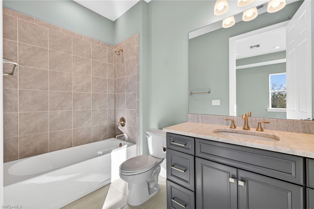 14523 Kelson Circle Naples, FL 34114 - Photo 31 of 50 a bathroom with a sink a toilet a mirror and bathtub