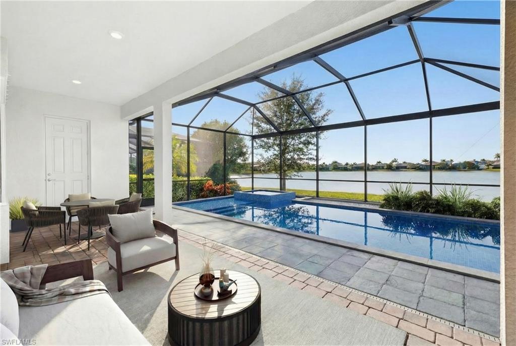 14523 Kelson Circle Naples, FL 34114 - Photo 36 of 50 a living room with furniture and a floor to ceiling window