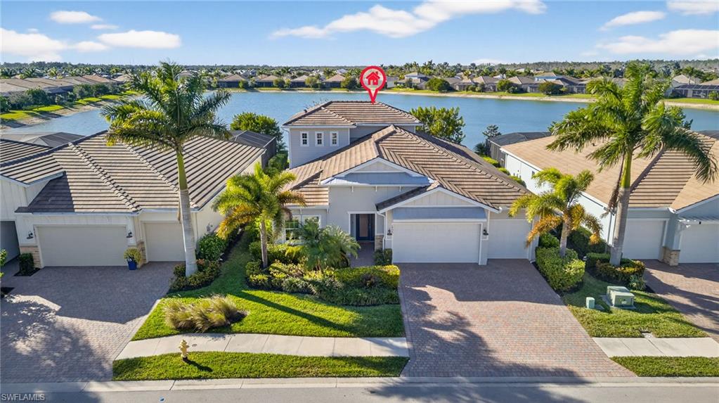14523 Kelson Circle Naples, FL 34114 - Photo 37 of 50 a front view of a house with a yard and potted plants