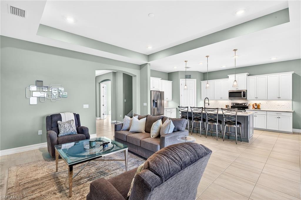 14523 Kelson Circle Naples, FL 34114 - Photo 5 of 50 a living room with furniture kitchen view and a large window