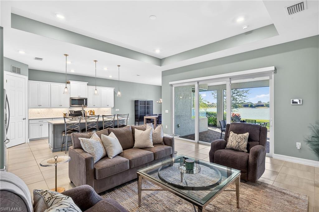 14523 Kelson Circle Naples, FL 34114 - Photo 6 of 50 a living room with furniture kitchen view and a large window