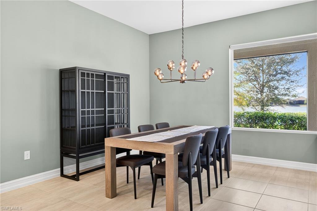14523 Kelson Circle Naples, FL 34114 - Photo 7 of 50 a view of a dining room that has a table and chairs