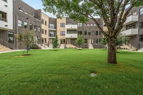 a view of a building with a yard