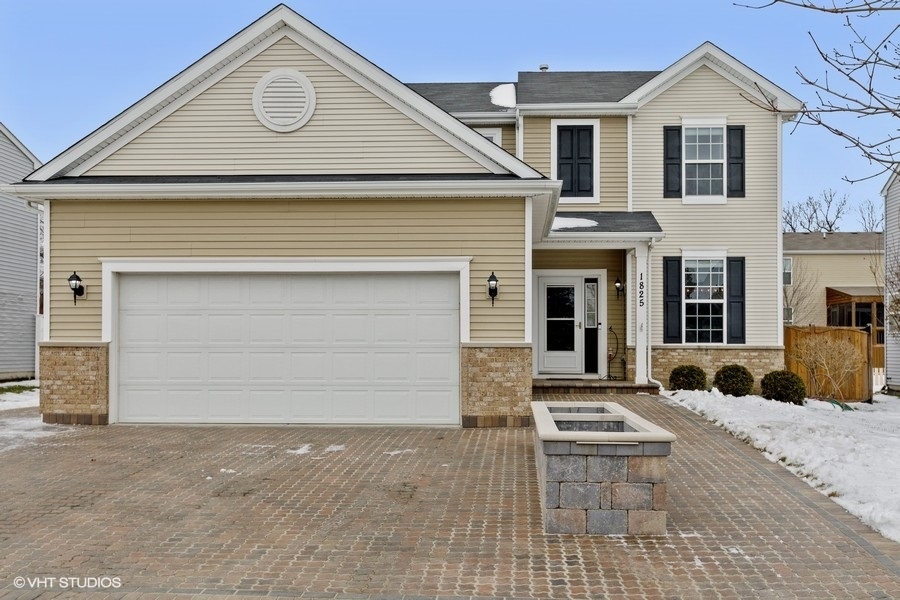 1825 Powers Road Woodstock, IL 60098 - Photo 1 of 18 a view of a white house with large windows