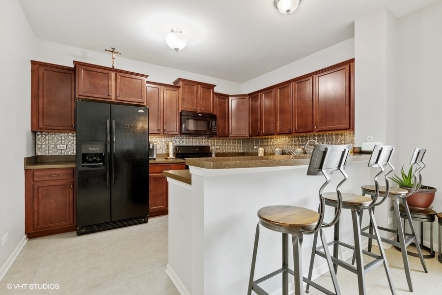 1825 Powers Road Woodstock, IL 60098 - Photo 4 of 18 a kitchen with stainless steel appliances granite countertop a refrigerator a stove a sink and dishwasher