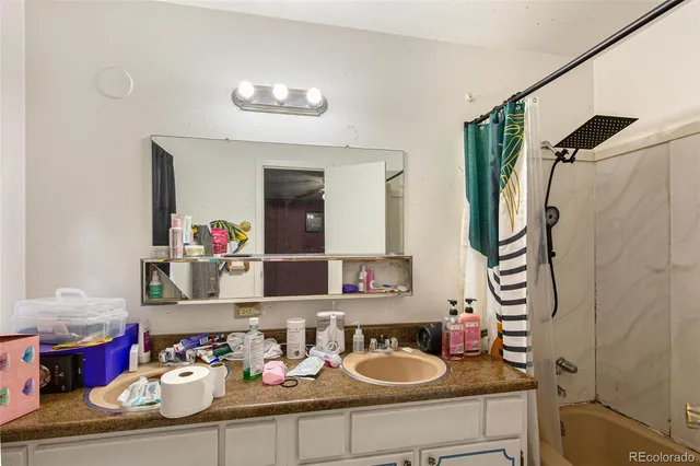 a bedroom with a bed a ceiling fan and a window