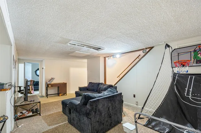 a living room with furniture and a mirror