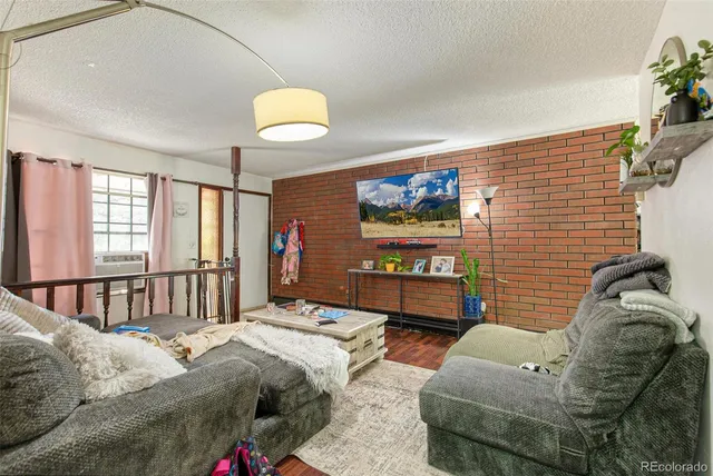 a bedroom with furniture and a large window