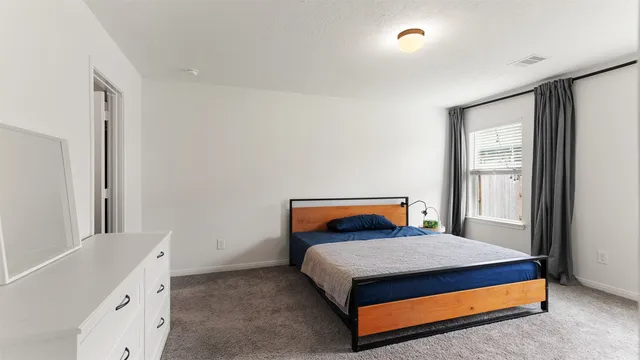 a bedroom with a bed and window