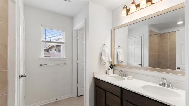 a bathroom with a double vanity sink and a mirror