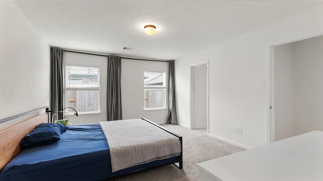 a bedroom with a bed and a large mirror