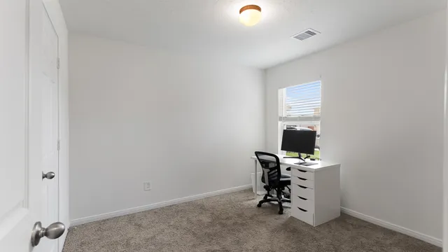 a view of a workspace with furniture