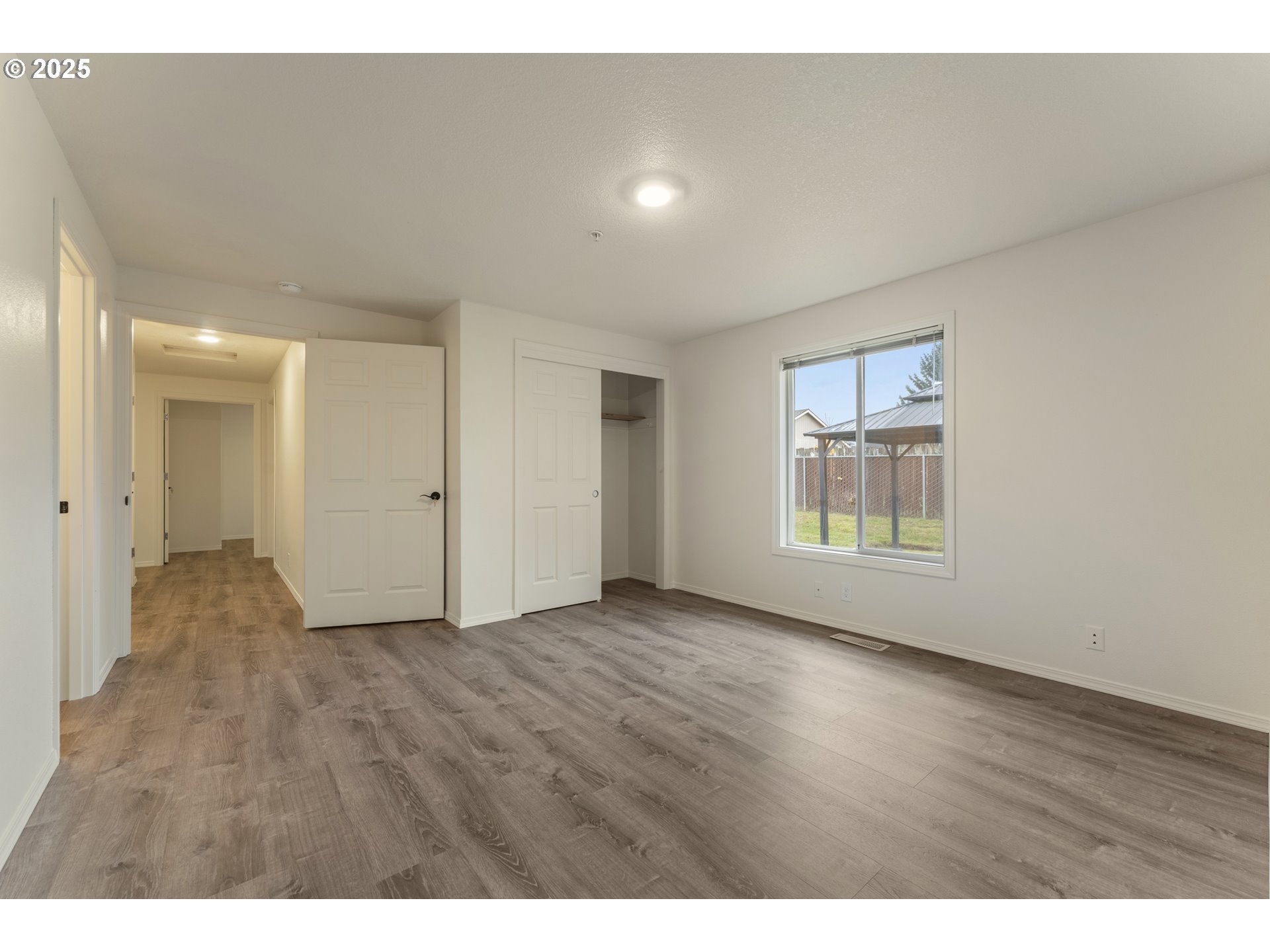 1530 Southeast 5th Street Gresham, OR 97080 - Photo 12 of 39 a view of an empty room with wooden floor and a window