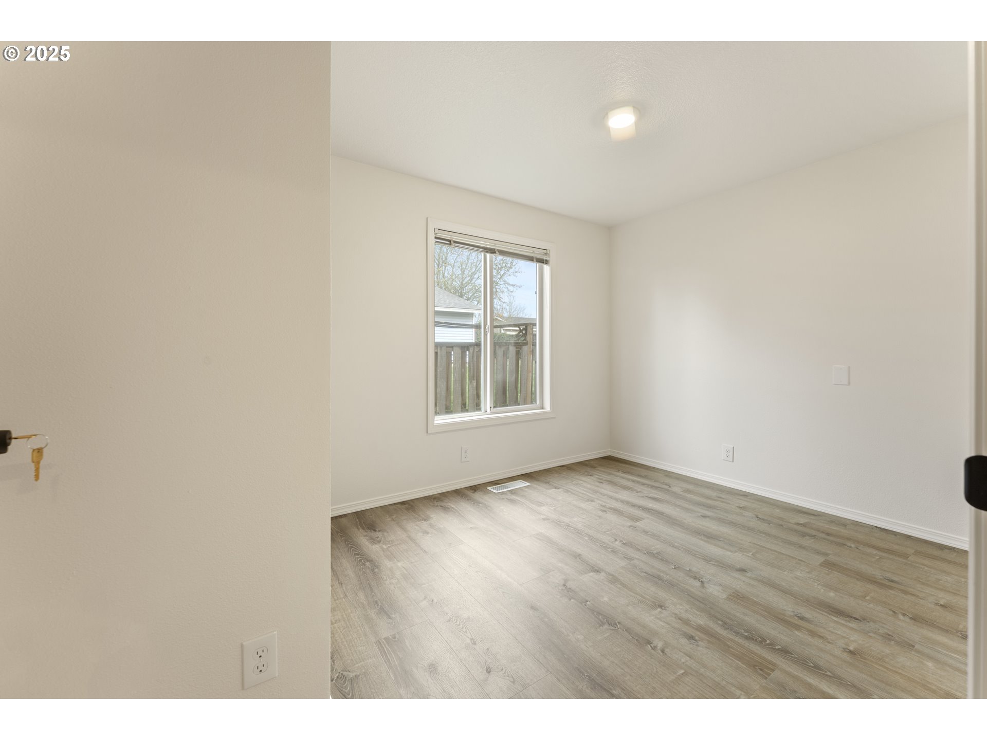 1530 Southeast 5th Street Gresham, OR 97080 - Photo 24 of 39 a view of an empty room with wooden floor and a window