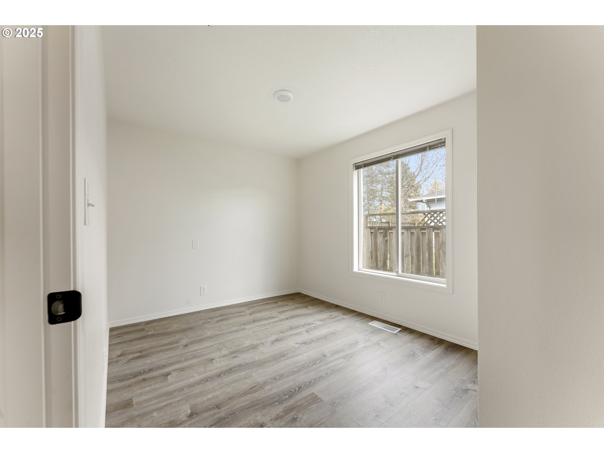 1530 Southeast 5th Street Gresham, OR 97080 - Photo 26 of 39 a view of an empty room with wooden floor and windows