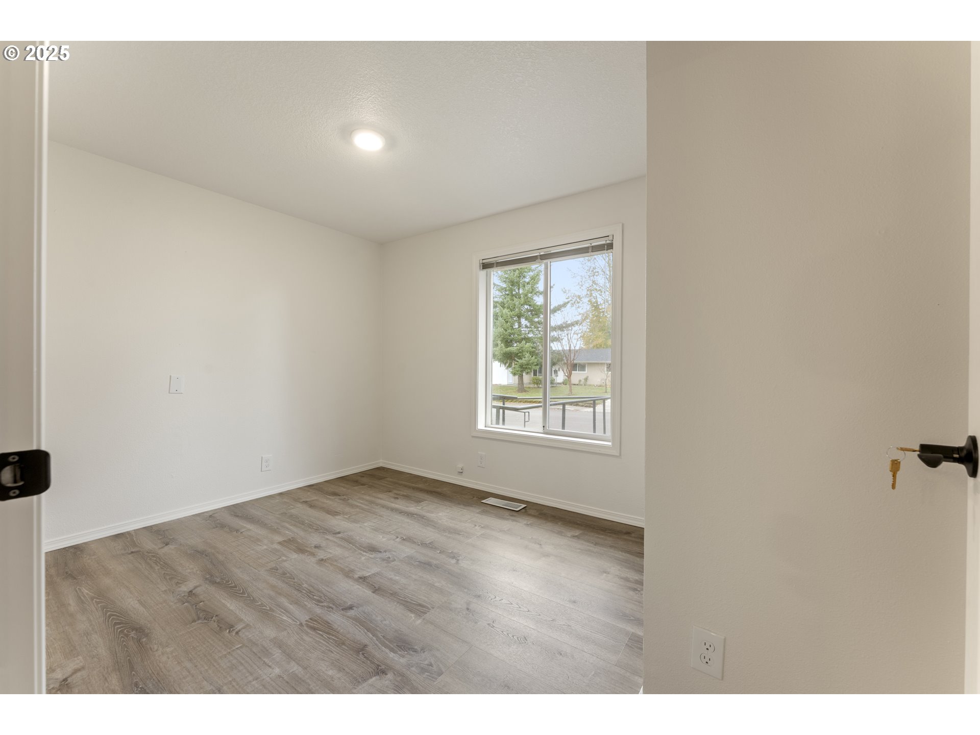 1530 Southeast 5th Street Gresham, OR 97080 - Photo 28 of 39 an empty room with wooden floor and windows
