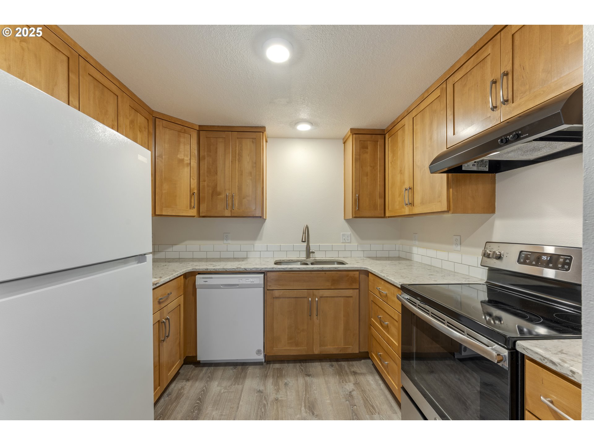 1530 Southeast 5th Street Gresham, OR 97080 - Photo 9 of 39 a kitchen with stainless steel appliances granite countertop a sink stove and refrigerator
