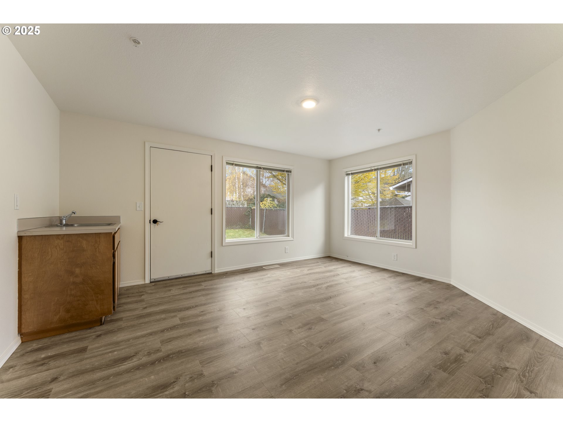 1530 Southeast 5th Street Gresham, OR 97080 - Photo 10 of 39 a view of an empty room with wooden floor and a window