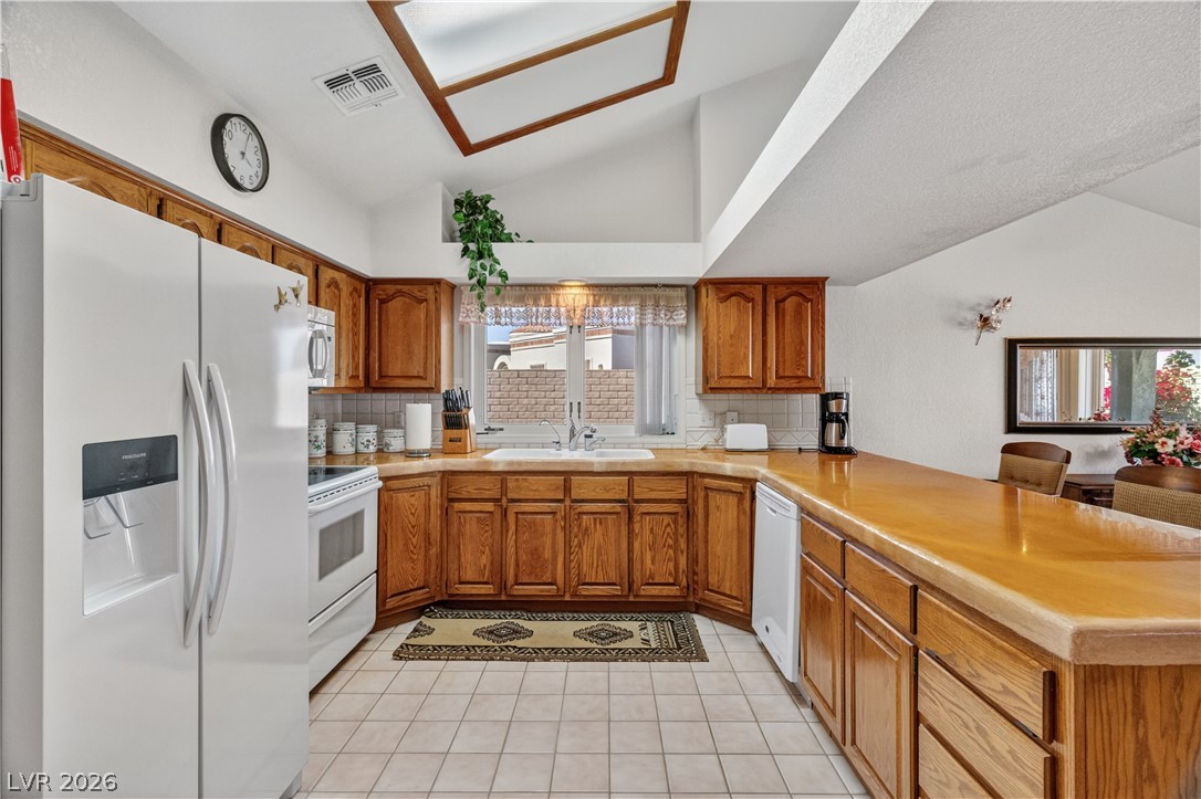 2055 Cholla Way Laughlin, NV 89029 - Photo 13 of 87 A well-lit kitchen with classic wood cabinetry and a functional layout.
