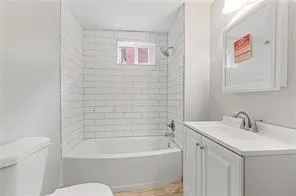 a bathroom with a sink a toilet and bathtub