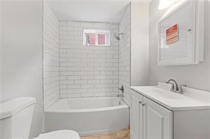 1005 Sheffield Street Pittsburgh, PA 15233 - Photo 7 of 11 a bathroom with a sink a toilet and bathtub
