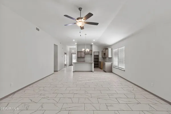 a view of a livingroom with a ceiling fan and wooden floor