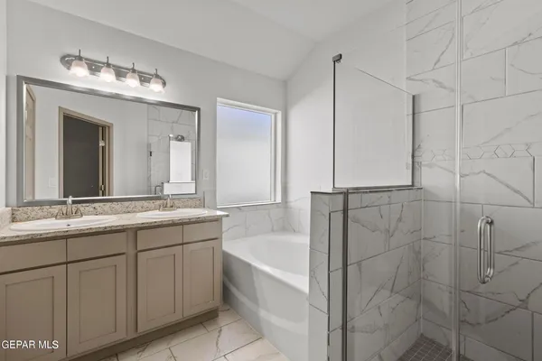 a bathroom with a tub sink and mirror