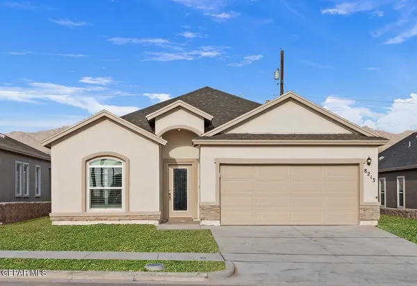 a view of a white house next to a yard