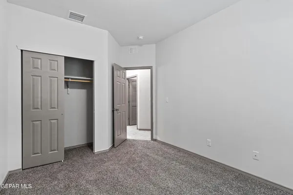 an empty room with closet area