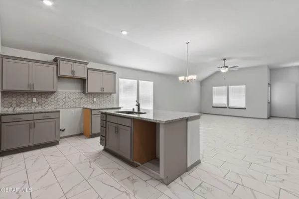 a kitchen with a sink cabinets and window