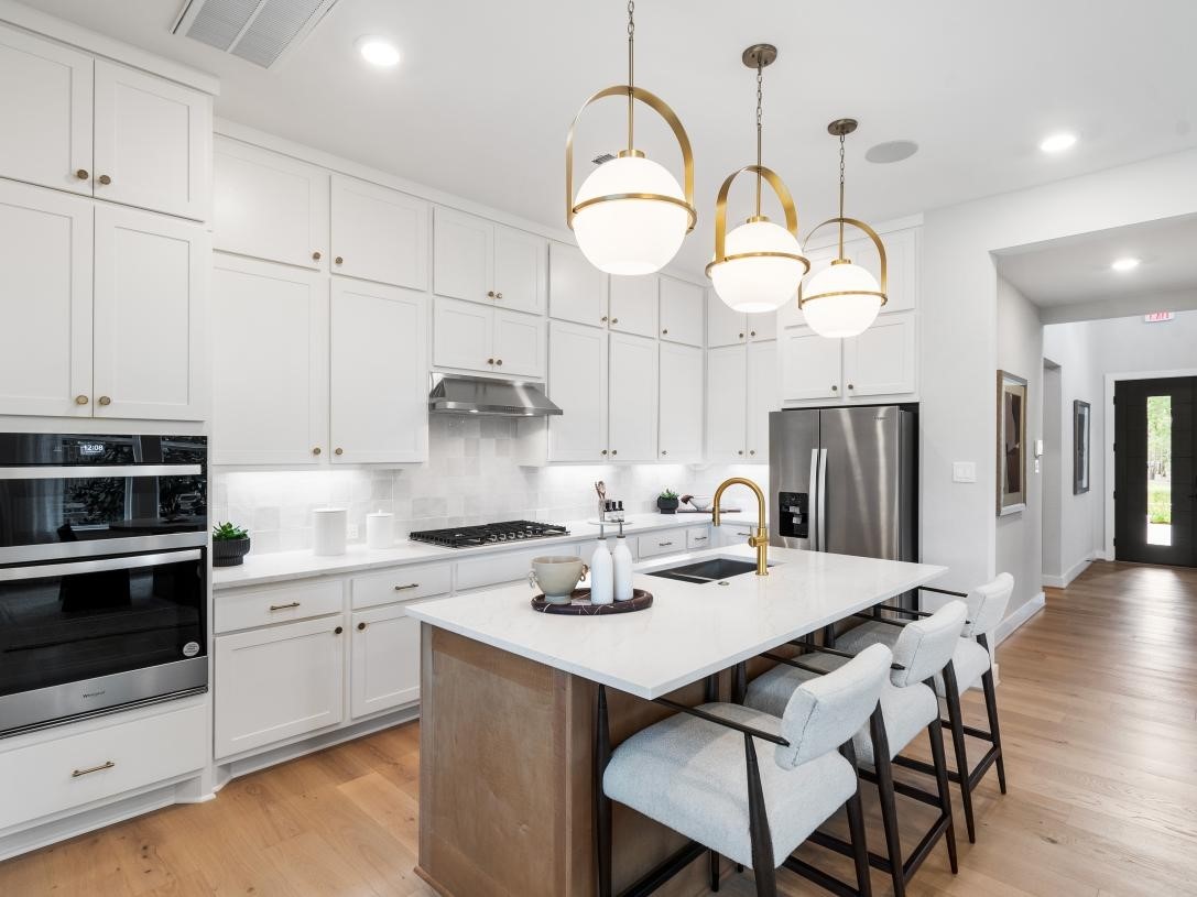 4938 Northern Wds Drive Spring, TX 77386 - Photo 3 of 11 a kitchen with stainless steel appliances kitchen island a table and chairs in it
