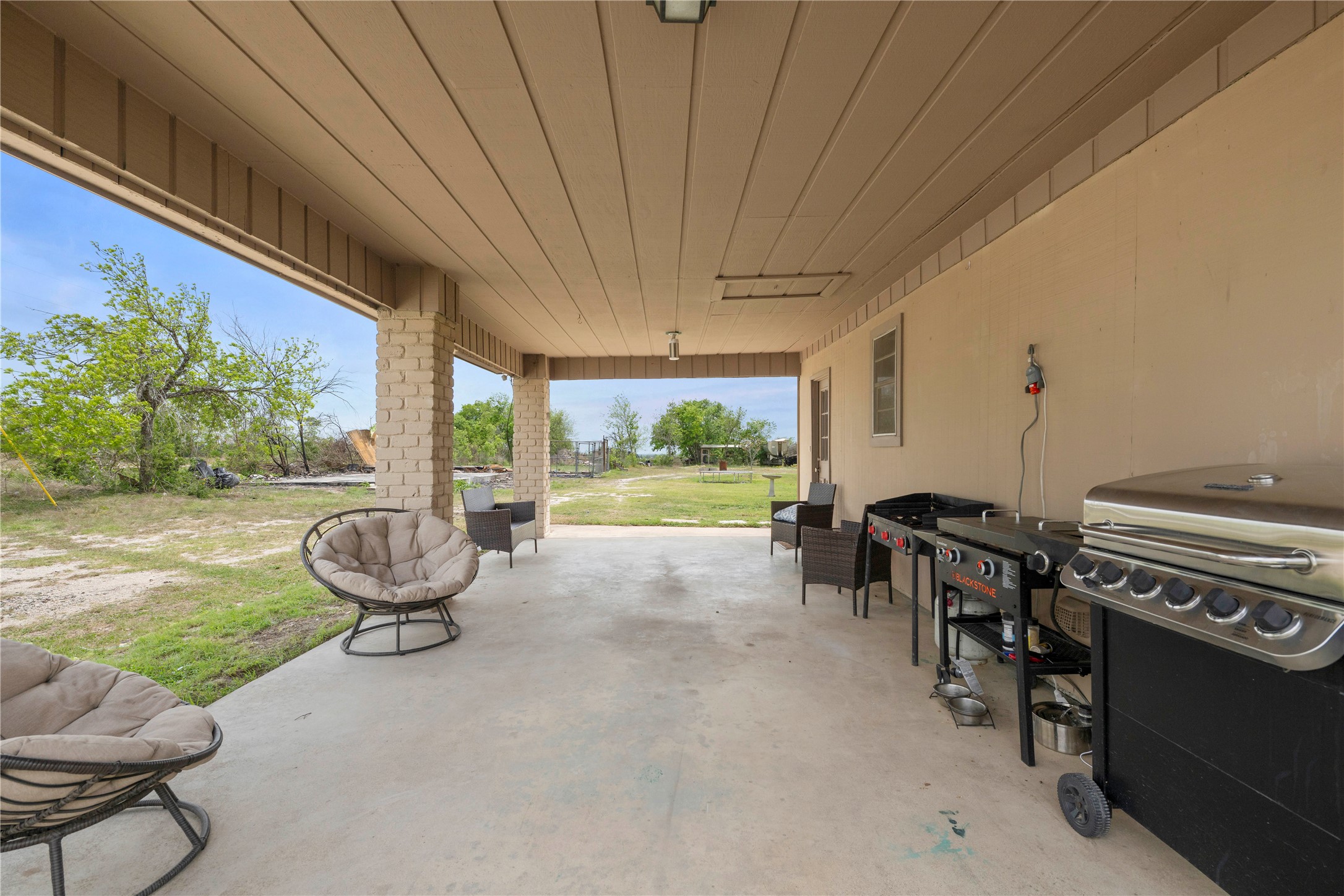 2915 County Road 153 Georgetown, TX 78626 - Photo 20 of 24 a view of a patio with table and chairs potted plants with wooden floor