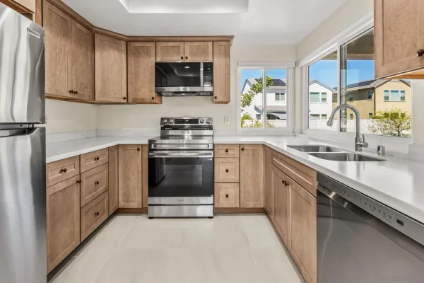 a kitchen with stainless steel appliances a sink stove and microwave