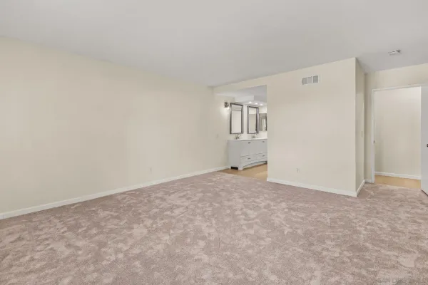 a view of an empty room with closet
