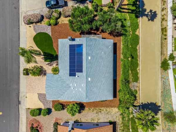 an aerial view of a house with a yard