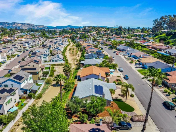 an aerial view of residential houses with outdoor space and street view
